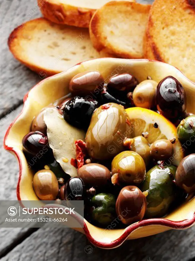 Bowl of Marinated Olives with Slices of Toasted Bread