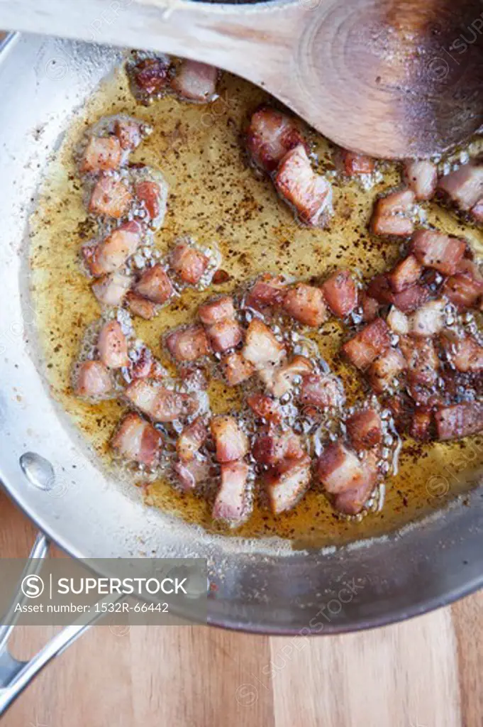 Crisping Chunks of Pancetta in Olive Oil in a Skillet