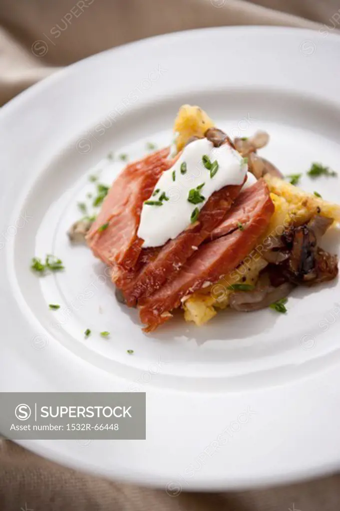 Smoked Salmon Slices on Polenta and Caramelized Onions with Cream and Chives