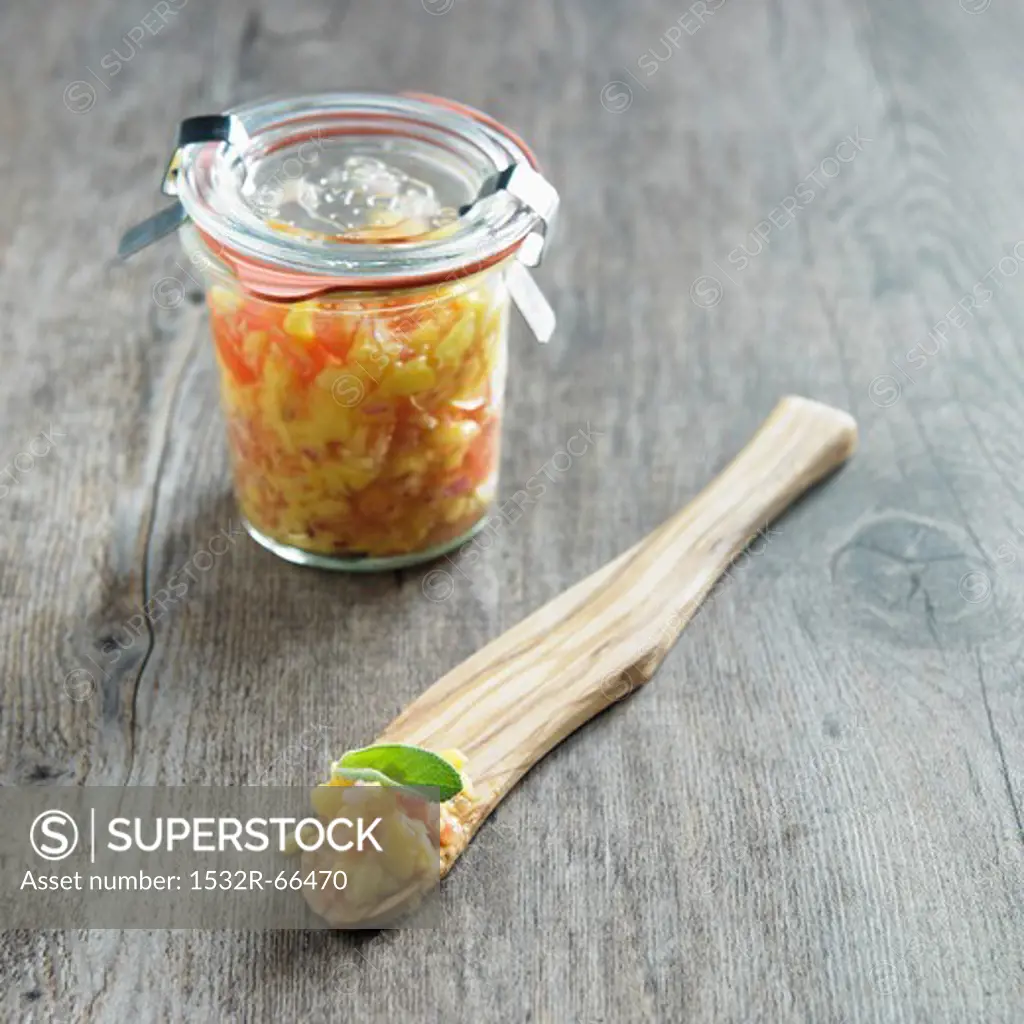 Jar of Homemade Mango Salsa; Some on a Wooden Spoon