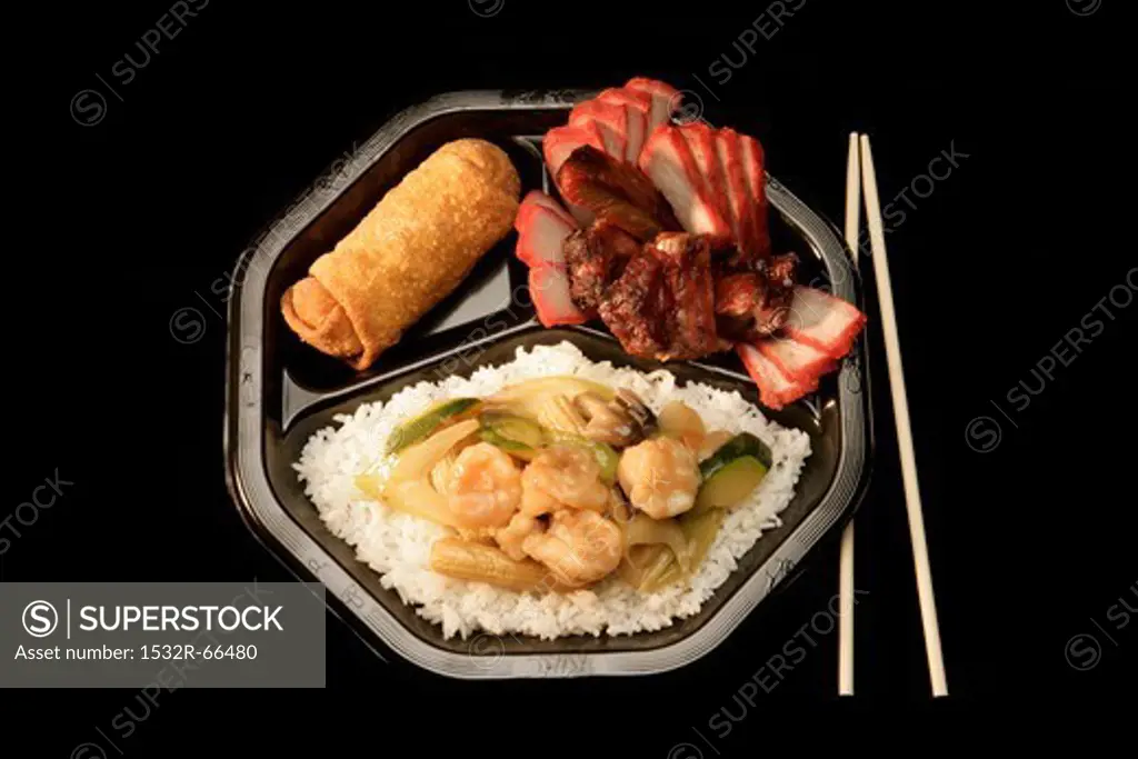 Assortment of Chinese Food on Black Plastic Plate<br />