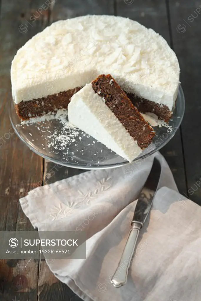 Poppy seed cake topped with coconut mousse, partly sliced