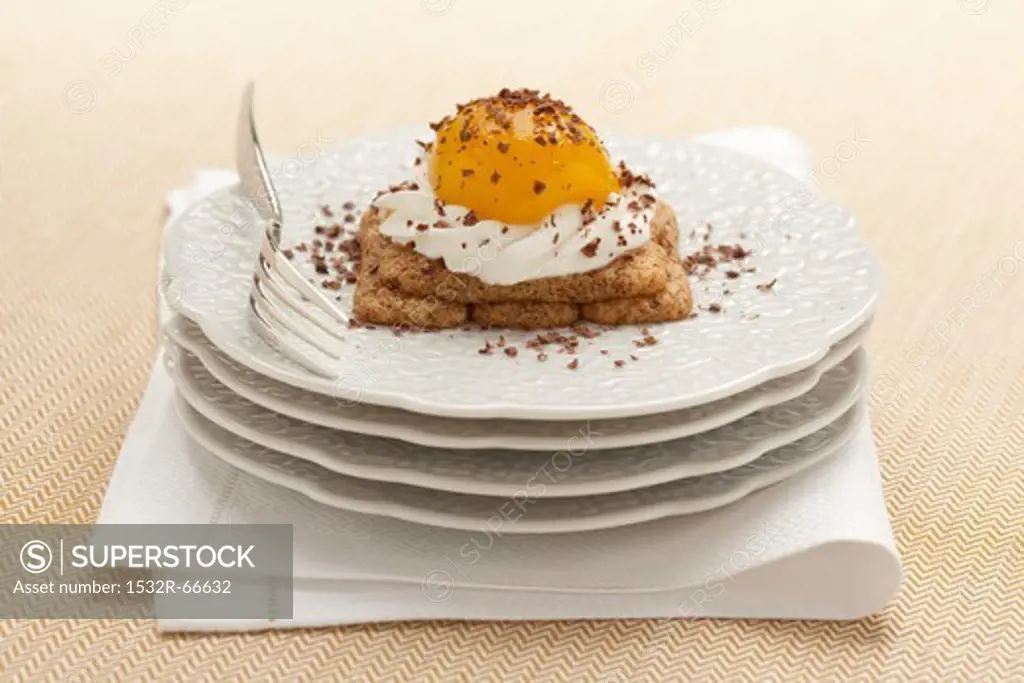 Uova al tegamino (sweet dessert with soaked sponge fingers, cream and peach)