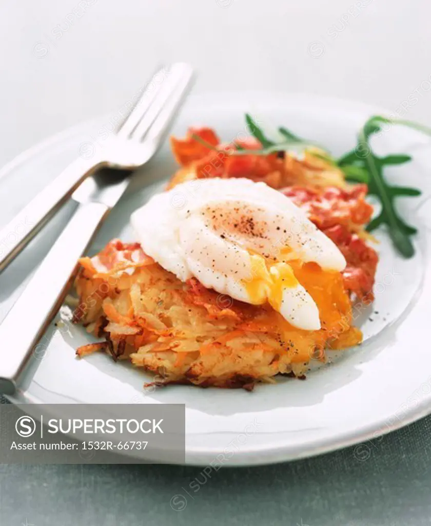 Potato and carrot fritter topped with a poached egg
