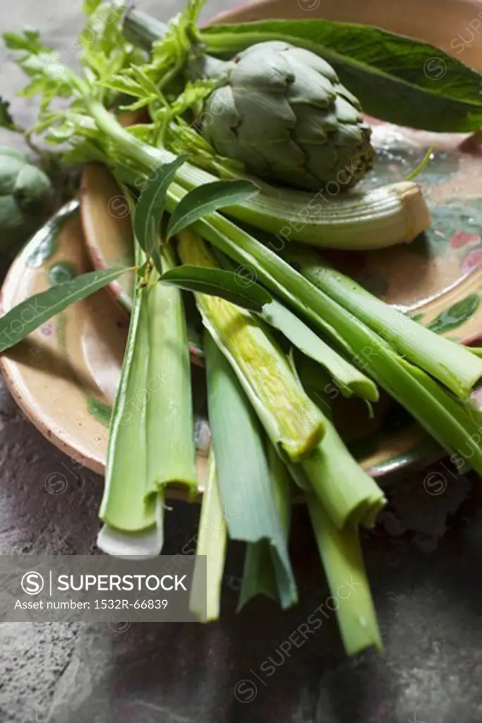 A still life of artichoke, leek and celery