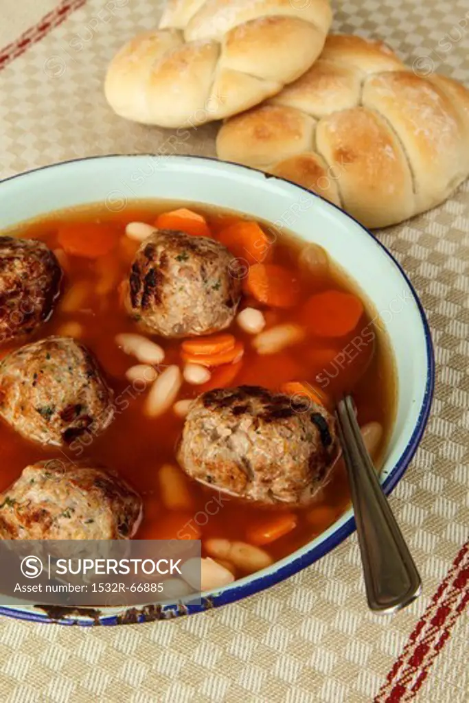 Vegetable broth with beans, carrots and meatballs