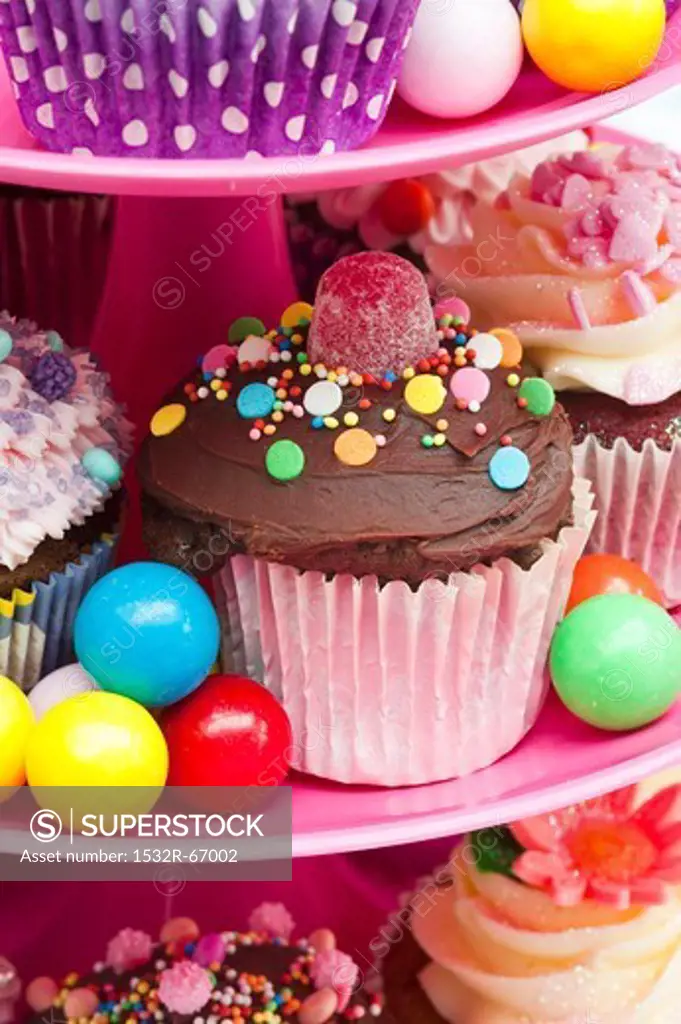 Colorful cupcakes and candies for a party on a cake stand