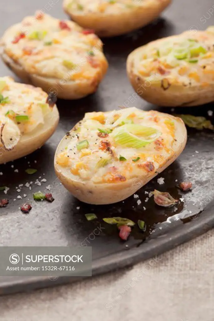 Stuffed baked potato halves with spring onions