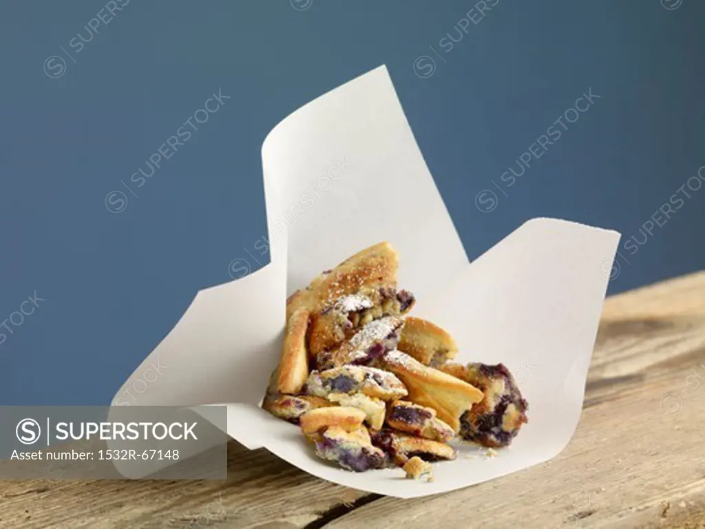 Kaiserschmarren (sweet cut up pancakes) with blueberries in paper