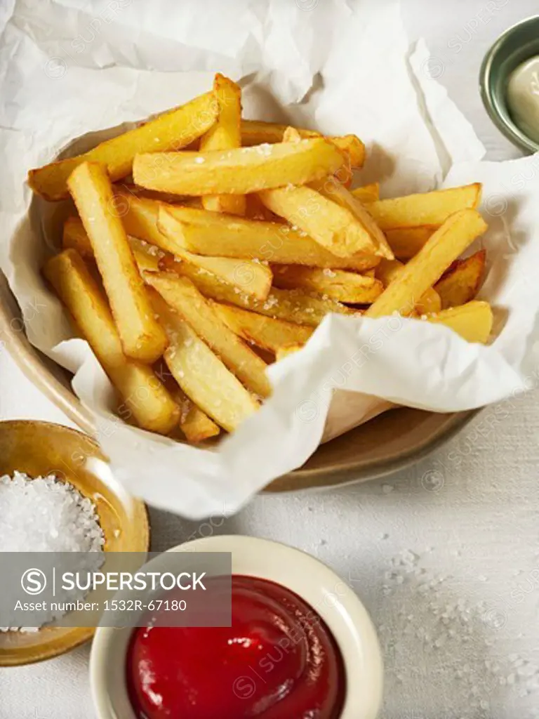 Home made French fries with coarse salt and ketchup