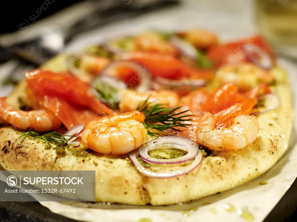 Pizza with salmon, shrimp and onions