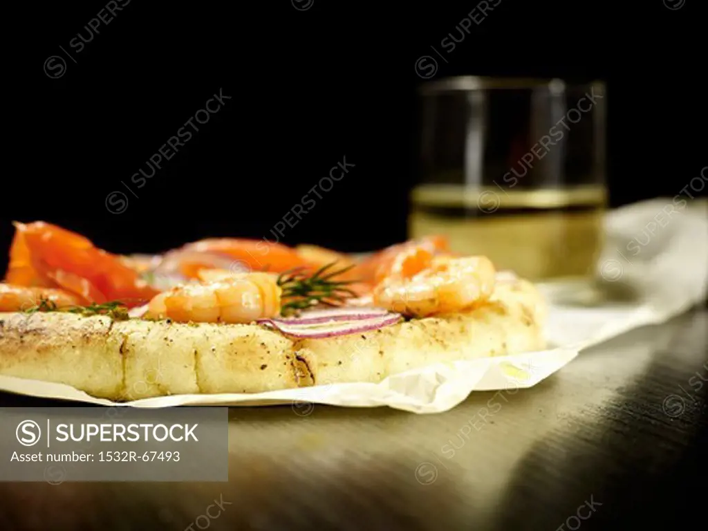 Pizza with salmon, shrimp and onions
