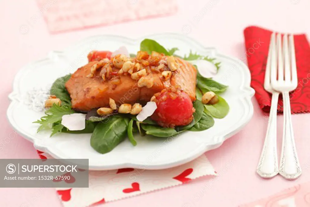Roasted salmon fillets with shallots, cherry tomatoes, hazelnuts and petals