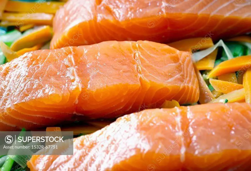 Salmon fillets on a bed of courgette, carrots and leek