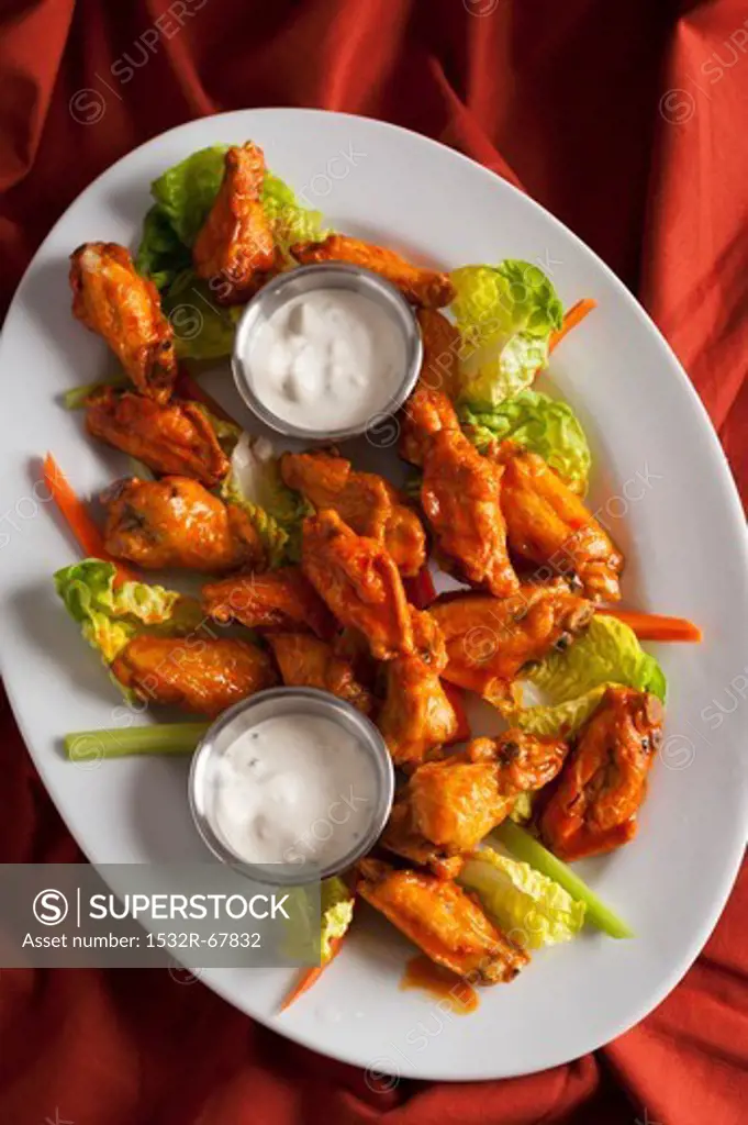 Platter of Buffalo Wings with Lettuce Leaves, Carrots and Celery Sticks and Small Bowls of Blue Cheese Dressing