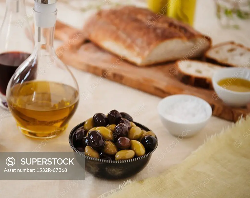 Bowl of Mixed Olives; Olive Oil and Bread in Background