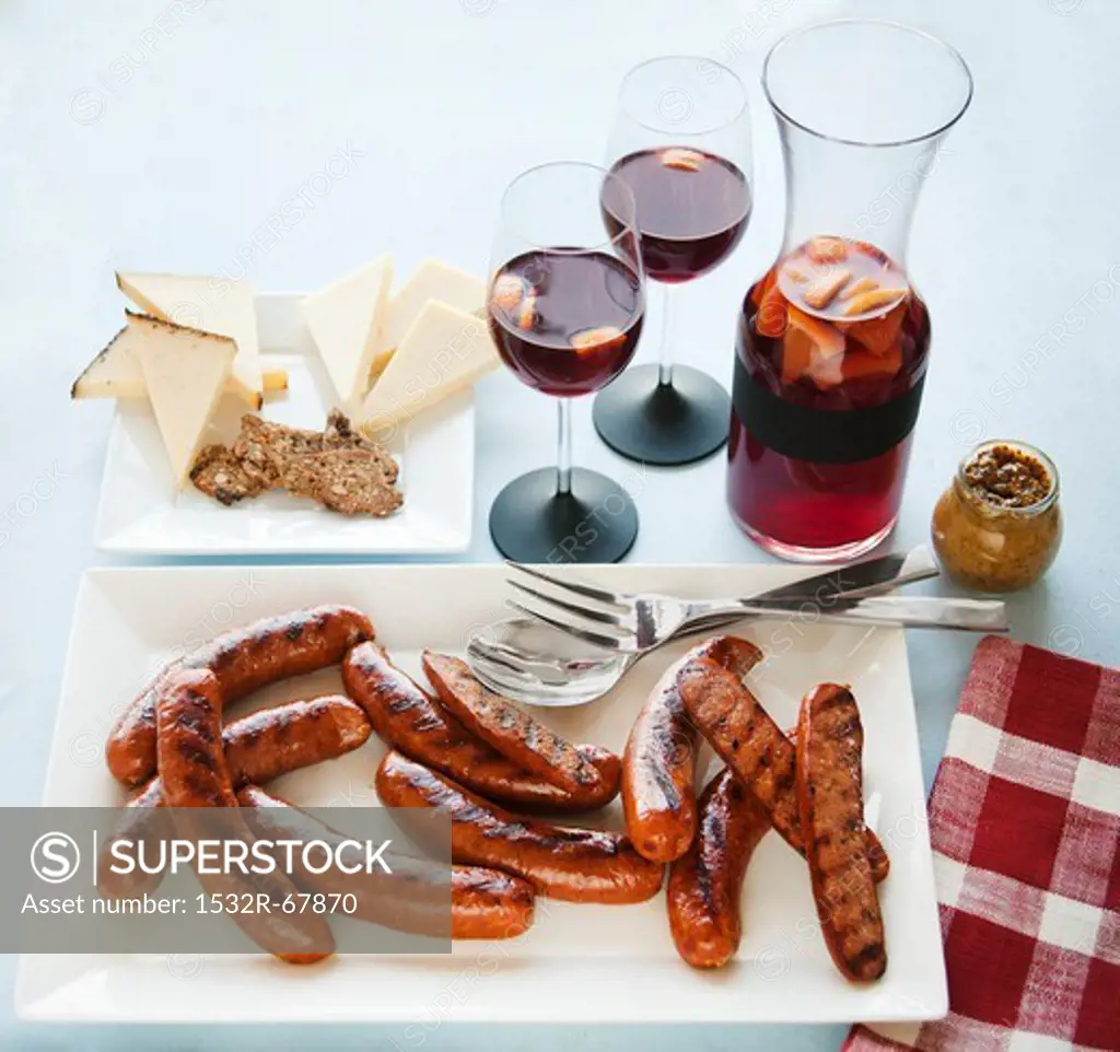 Platter of Grilled Sausages, Cheese Plate and Glasses and Pitcher of Sangria