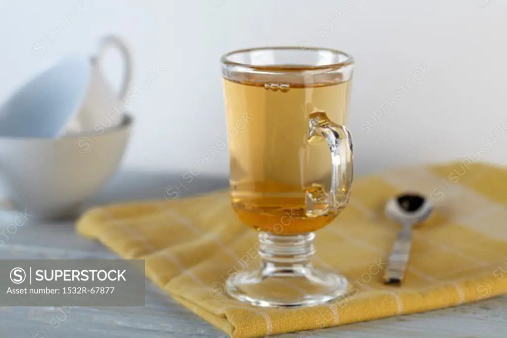 A Glass of Honey Ginger Apple Cider on a Yellow Towel