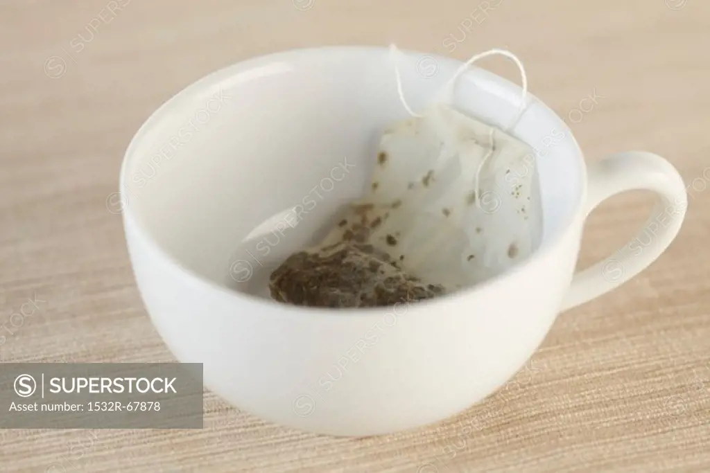 A Used Tea Bag in an Empty White Tea Cup