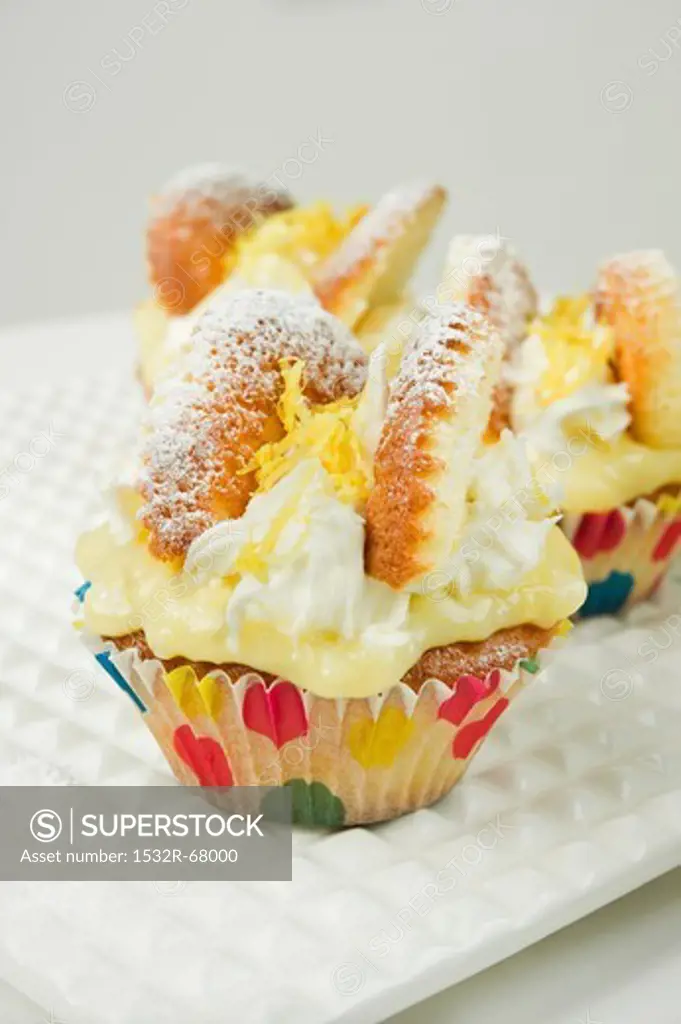 lemon and cream fairy cakes on a white plate