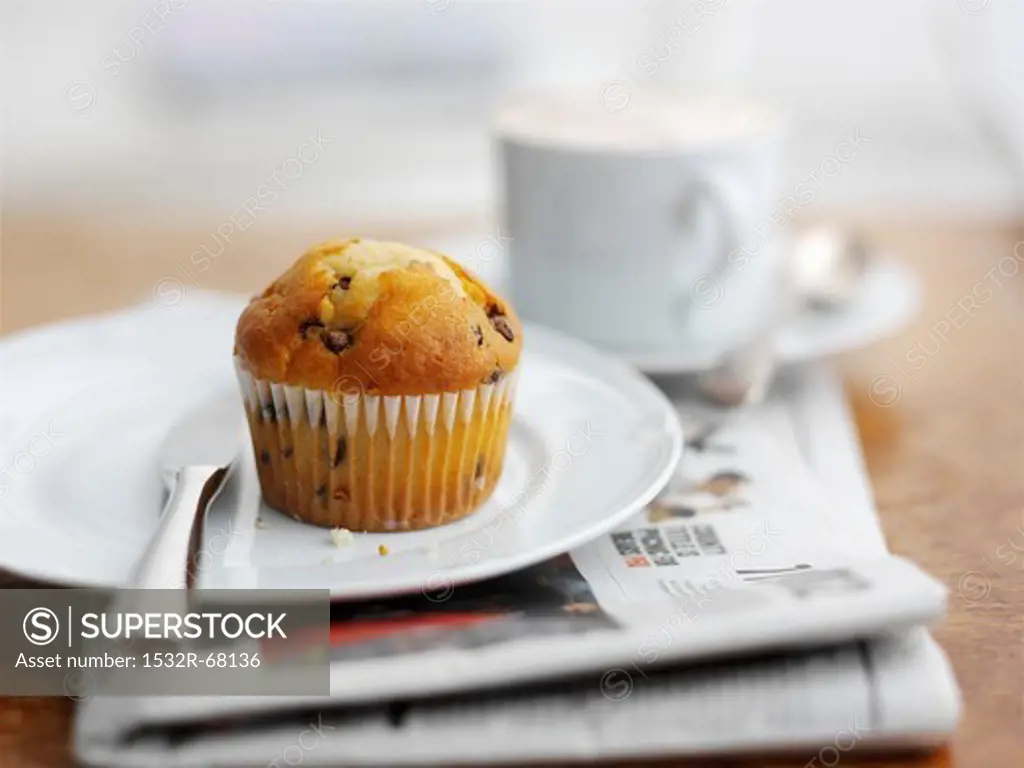 A muffin with a cup of coffee for breakfast