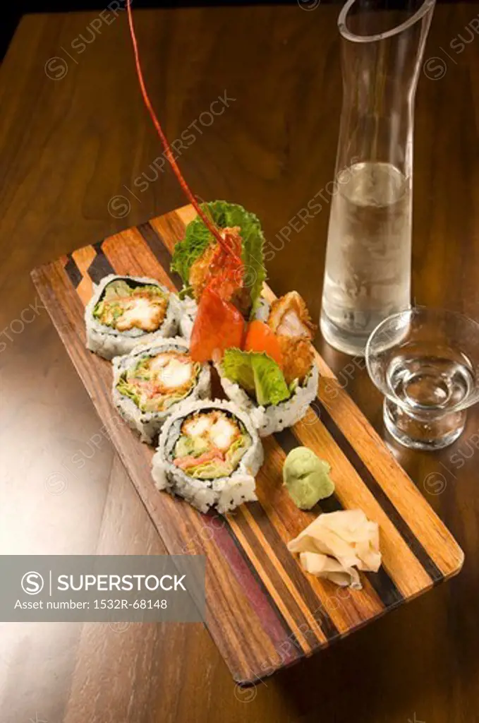 Lobster Sushi on a Wooden Platter; Pitcher and Glass of Sake