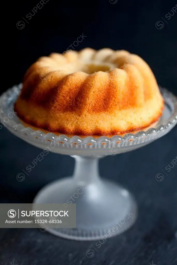Mini lemon sponge bundt cake on vintage glass cake stand