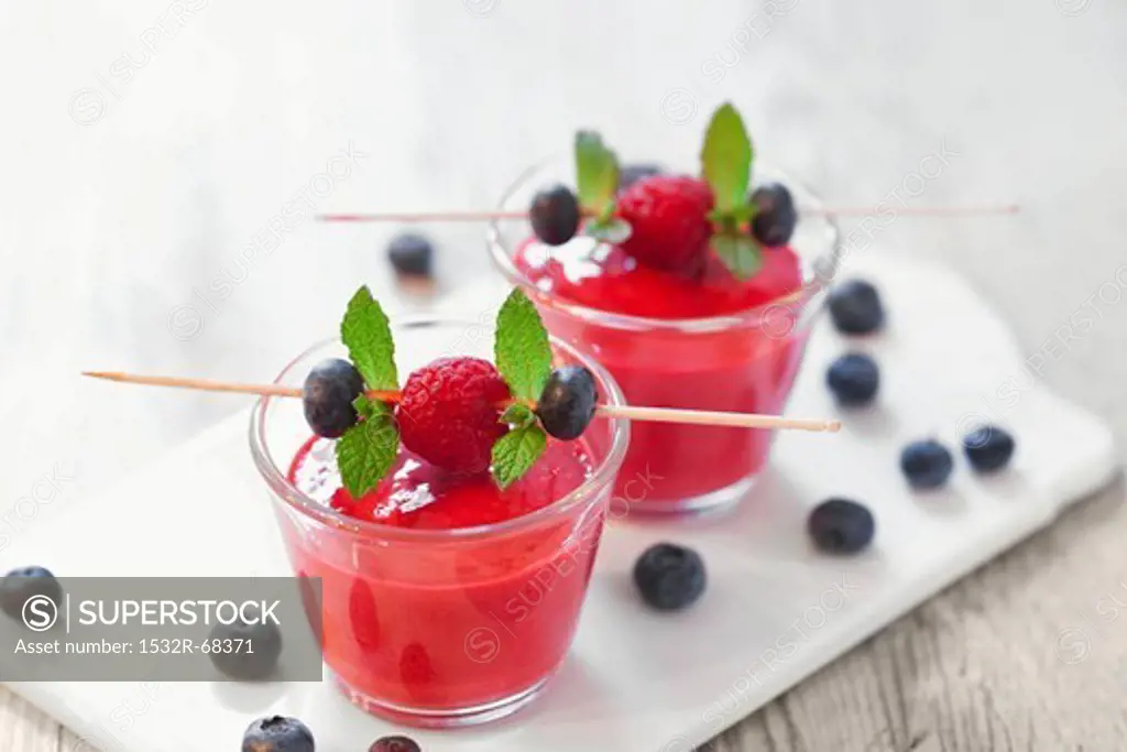 Raspberry and blueberry smoothies on a chopping board