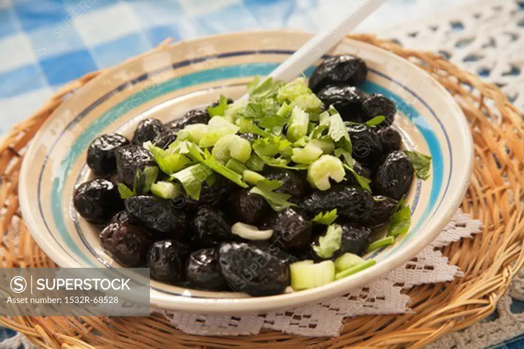 A Bowl of Marinated Black Olive Salad with Celery