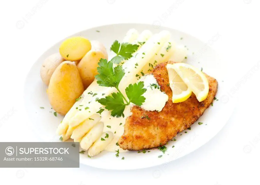 White asparagus and a schnitzel with Hollandaise sauce and potatoes