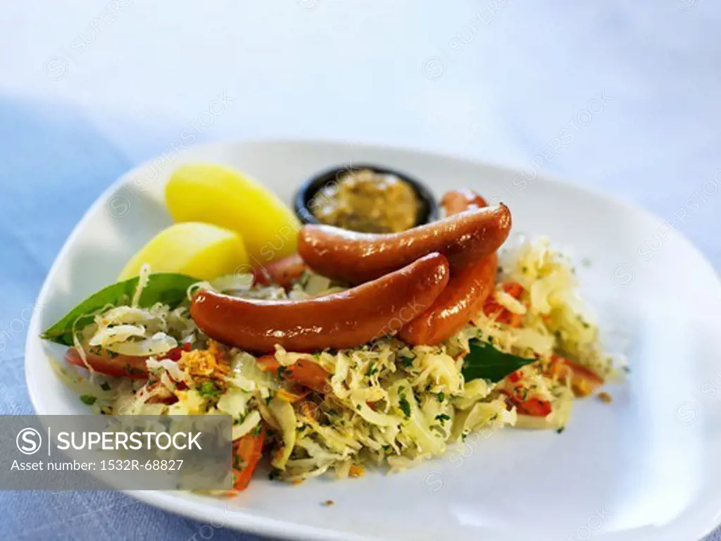Sausages with cabbage salad, mustard and potatoes
