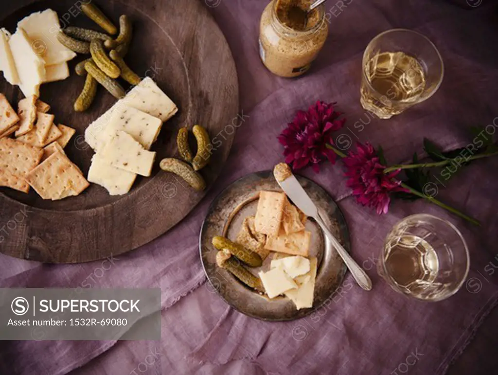 Assorted Cheese, Crackers, Gherkin Pickles and Glasses of White Wine