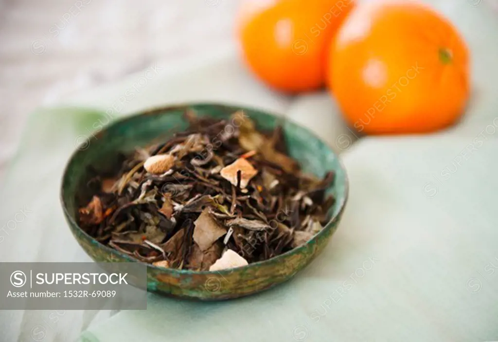 A Bowl of Oolong Tea; Two Oranges in the Background