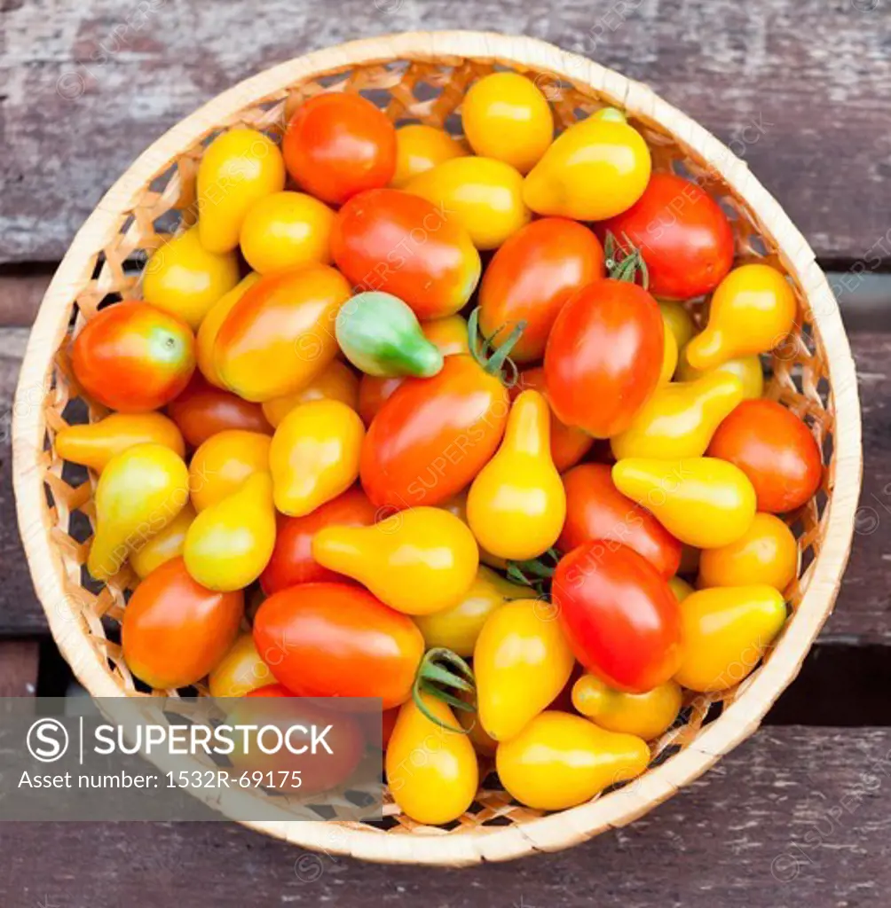 Pear and Grape Tomatoes in a Basket; From Above