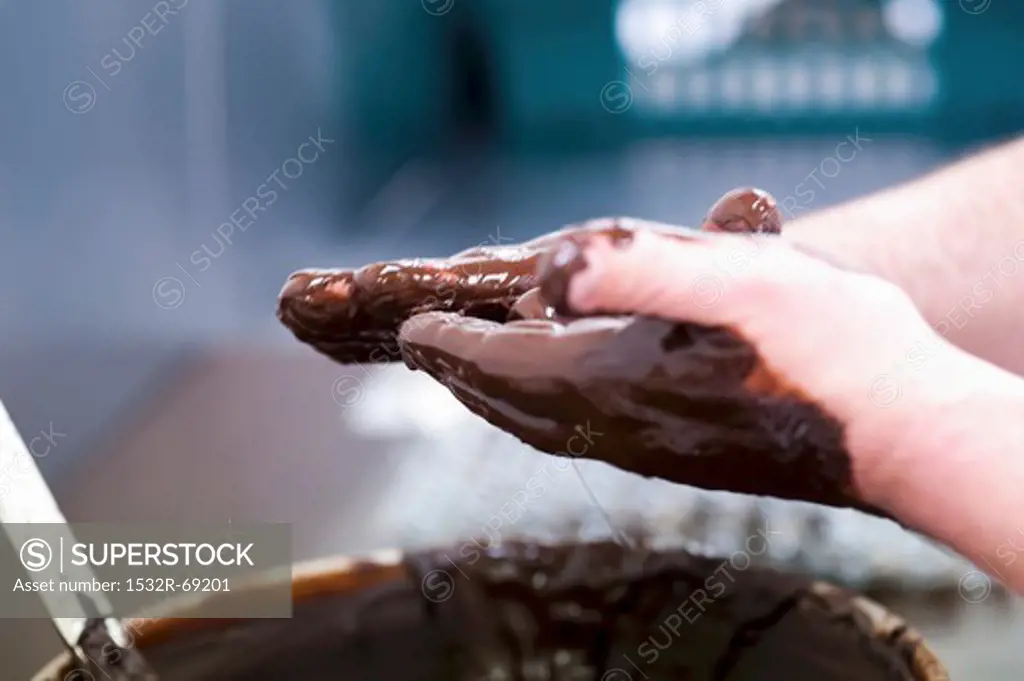 Truffles being rolled in melted chocolate