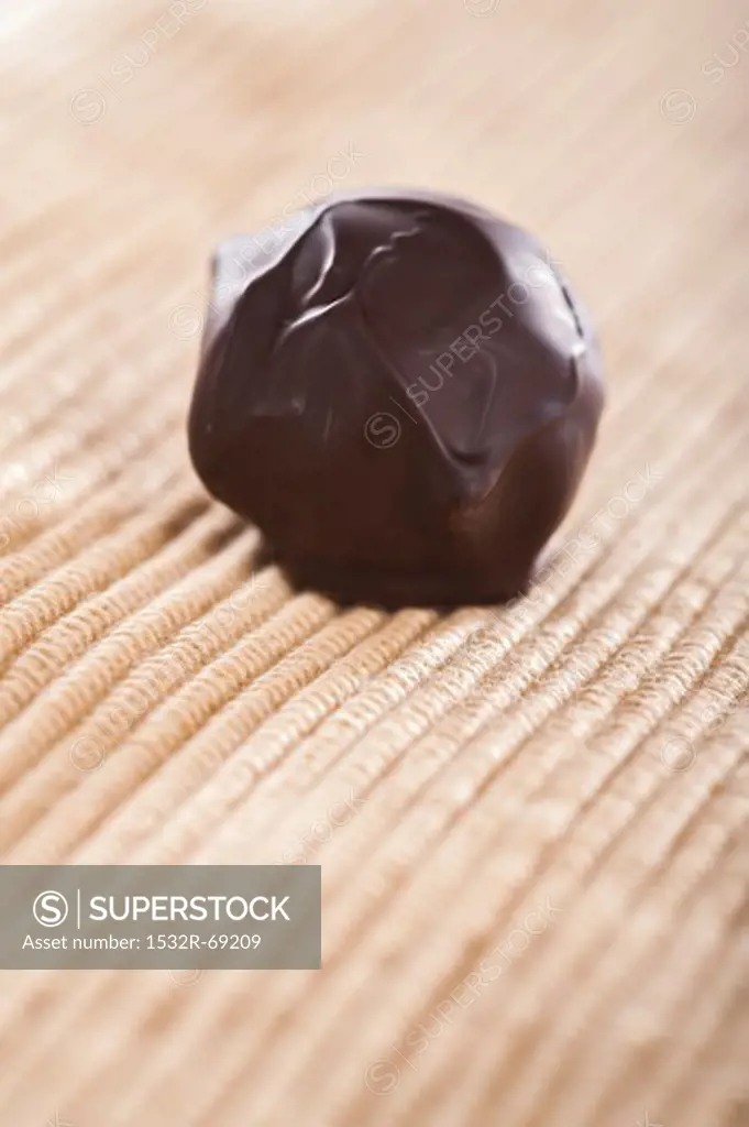 A home-made chocolate truffle coated in dark chocolate