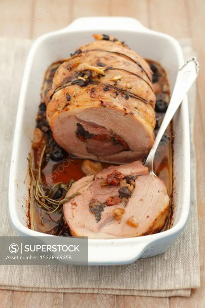 Stuffed collar of pork with olives, sun-dried tomatoes and celery