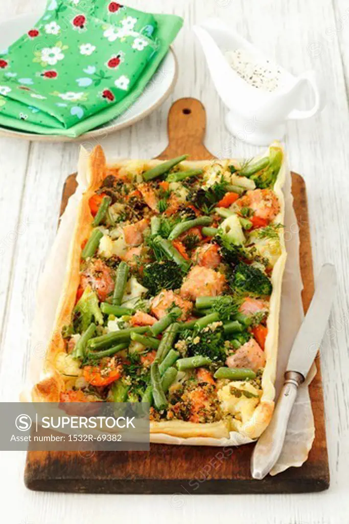 A cauliflower, broccoli, carrot and salmon tart