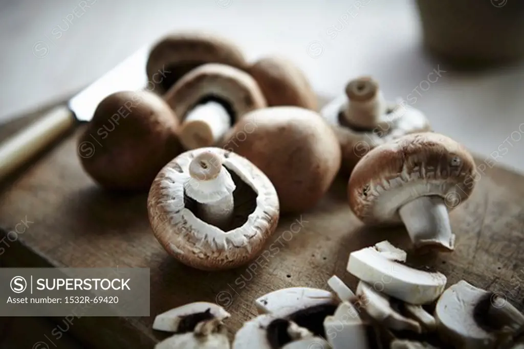 Button mushrooms on a wooden board