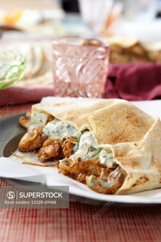Chicken with herb sauce in pita bread