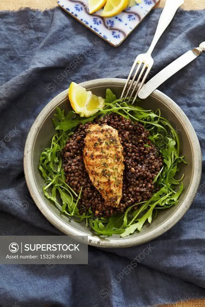 Chicken breast on lentils with rocket