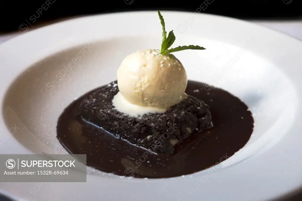 A brownie with chocolate sauce and vanilla ice cream