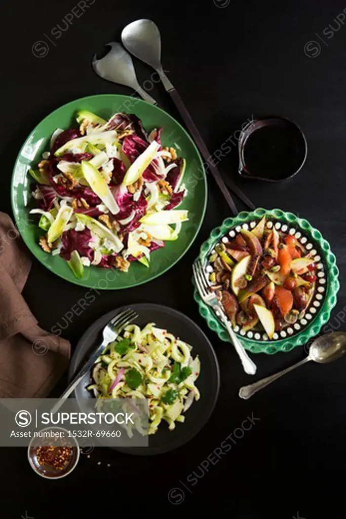 Assorted salads on a black background