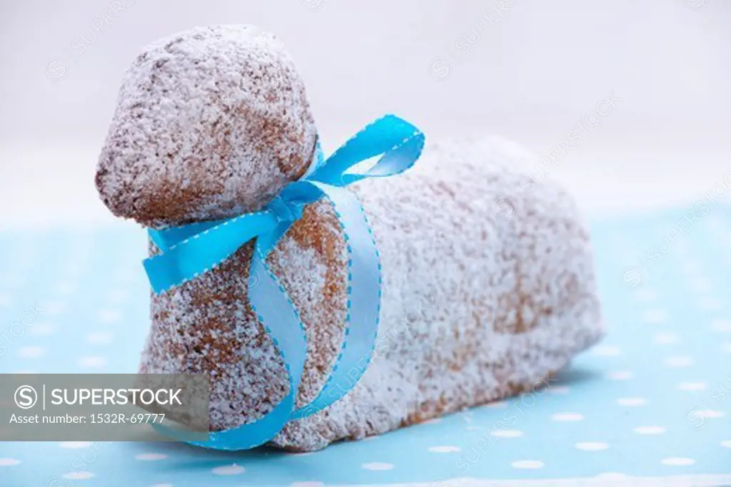 A sweet Easter lamb cake with a blue ribbon