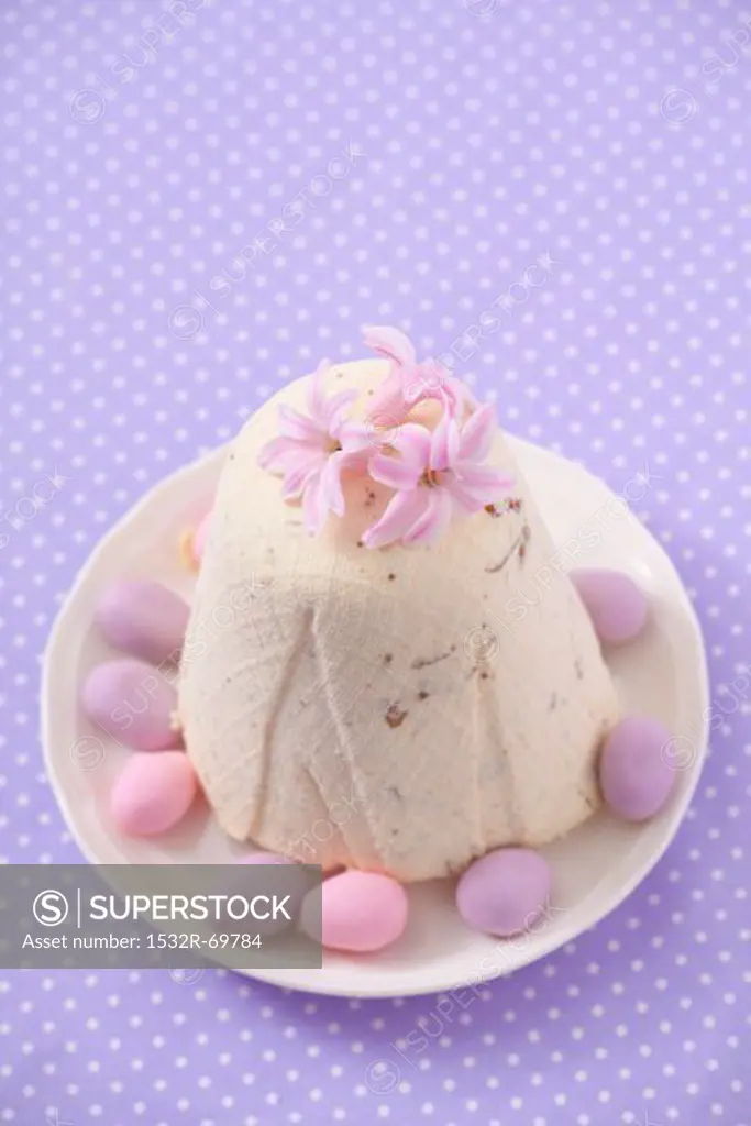 Pashka (quark dessert, Poland) with pink flowers and marzipan eggs for Easter