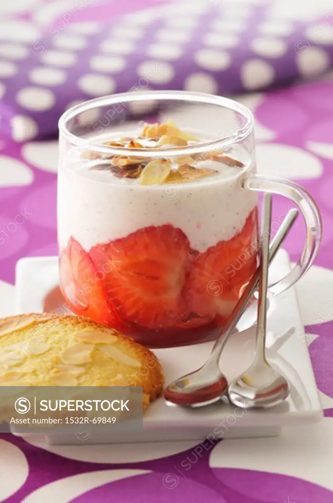 Vanilla custard with strawberries and sliced almonds; served with almond biscuits