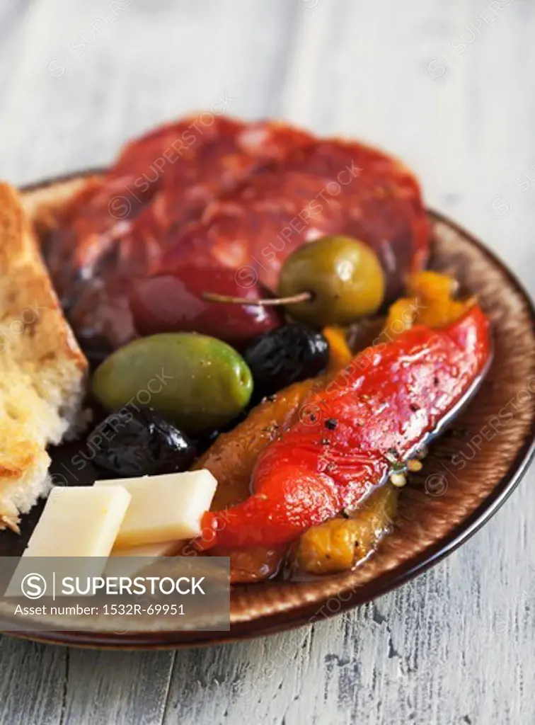 Antipasto with Fire Roasted Red and Yellow Peppers, Mixed Olives, Provolone Cheese, Sopressata and Italian Bread