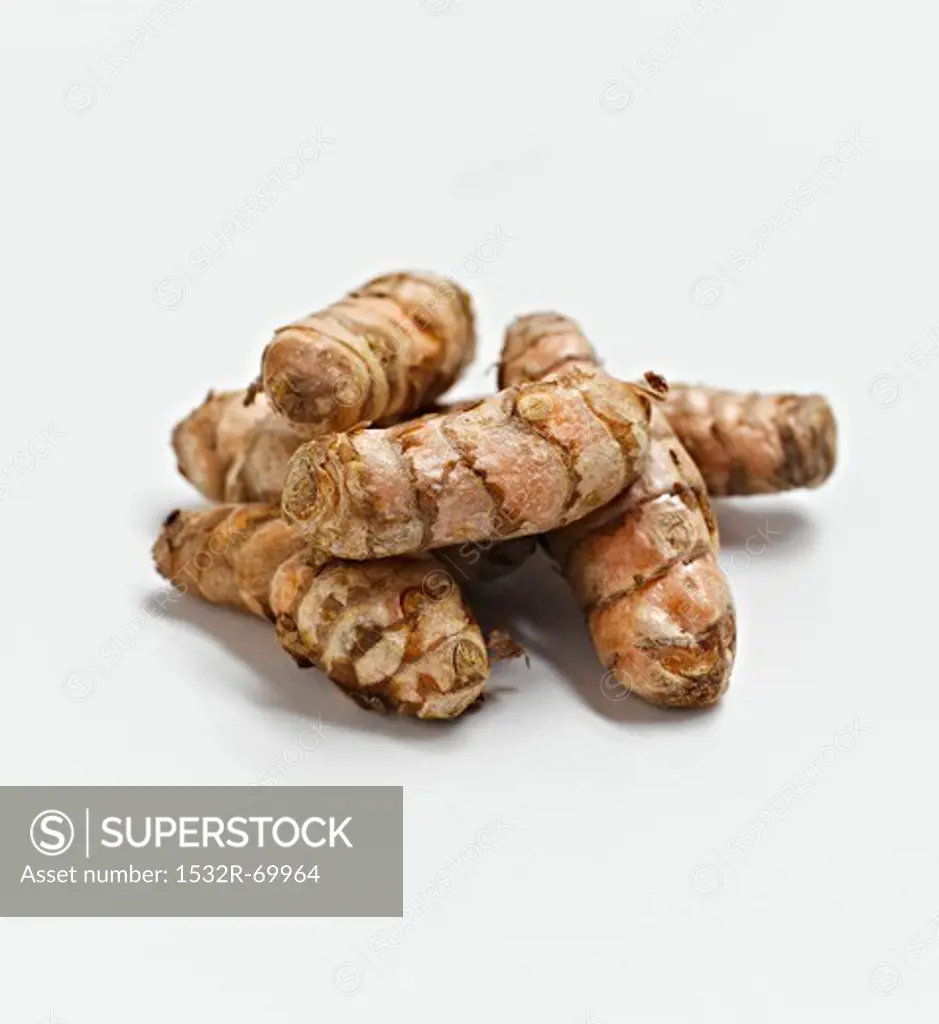 Whole Turmeric Roots on a White Background