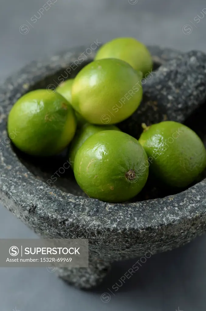 Fresh Limes in a Mortar Bowl