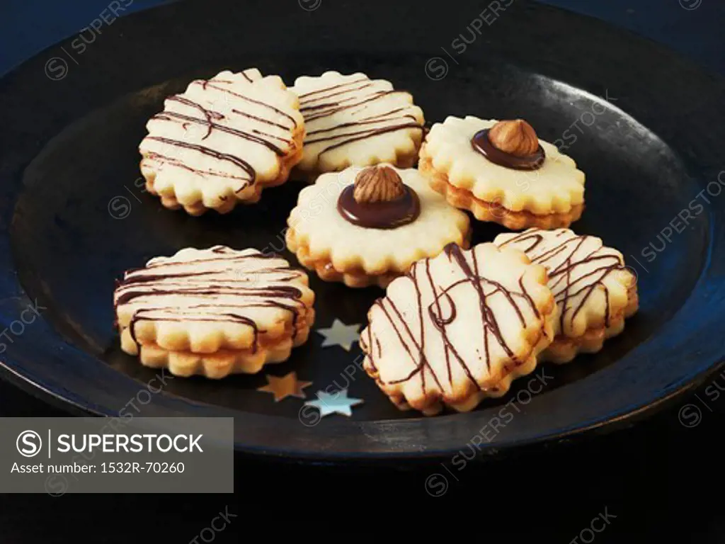 Christmas biscuits with chocolate stripes and hazelnuts